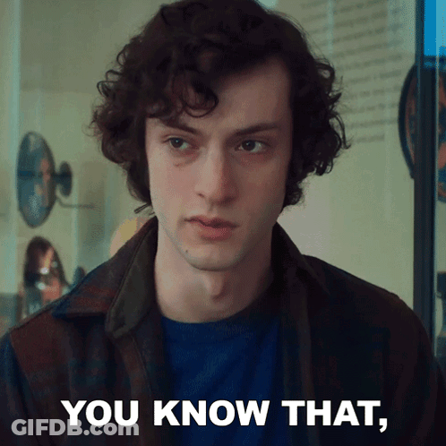 A Man With Curly Hair Says " You Know That " In Front Of A Mirror GIF