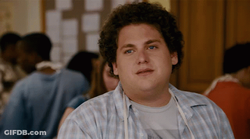 A Man With Curly Hair Wearing A Blue Plaid Shirt GIF