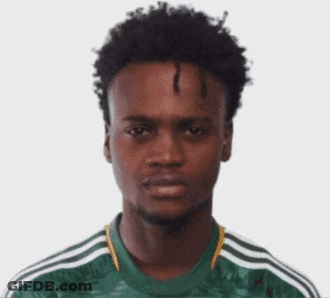 A Man With Curly Hair Wearing A Green Adidas Shirt GIF