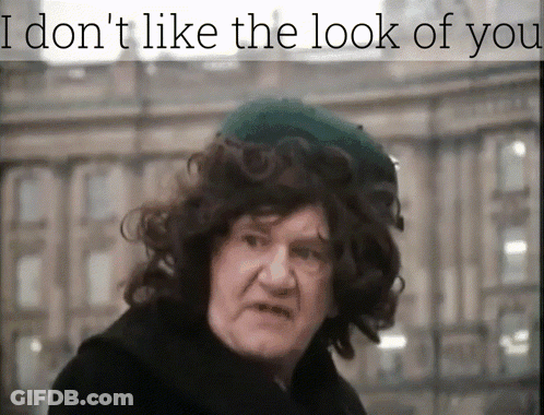A Man With Curly Hair Wearing A Green Hat With The Words I Don 'T Like The Look Of You Above Him GIF