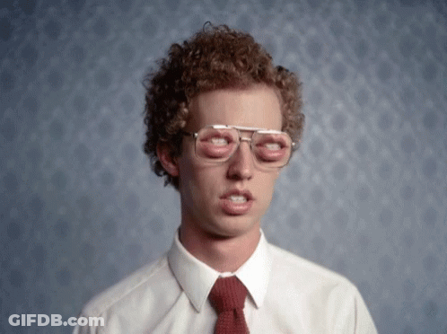 A Man With Curly Hair Wearing Glasses And A Red Tie GIF