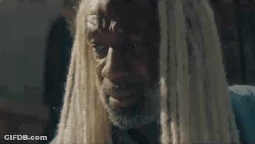 A Man With Dreadlocks And A Beard Is Crying And Looking At The Camera . GIF