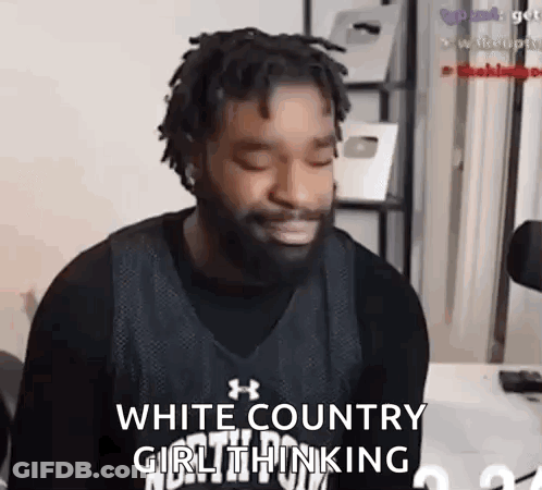 A Man With Dreadlocks And A Beard Is Sitting In Front Of A Microphone And Making A Face . GIF