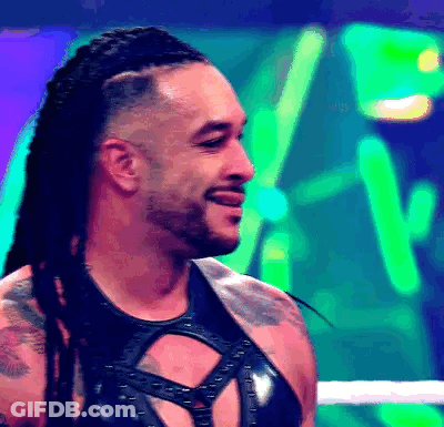 A Man With Dreadlocks And A Beard Is Smiling In A Boxing Ring . GIF
