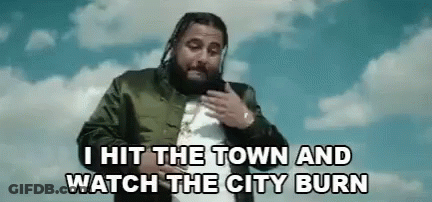 A Man With Dreadlocks And A Beard Is Standing In Front Of A Blue Sky With Clouds . GIF