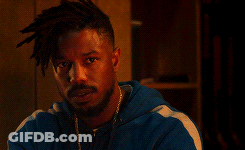 A Man With Dreadlocks And A Beard Is Wearing A Blue Jacket GIF