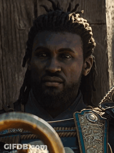 A Man With Dreadlocks And A Beard Is Wearing Armor GIF