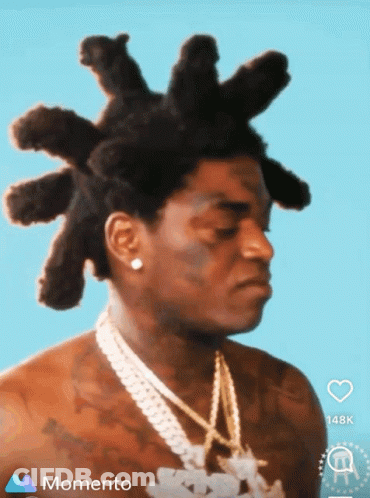 A Man With Dreadlocks And A Chain Around His Neck Is On A Momento Screen GIF