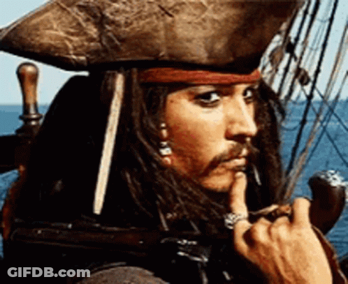 A Man With Dreadlocks And A Hat Is Sitting On A Boat With His Finger In His Mouth . GIF