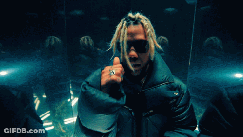 A Man With Dreadlocks And A Ring On His Finger Giving A Thumbs Up GIF