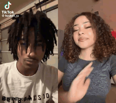 A Man With Dreadlocks And A Woman With Curly Hair Are Dancing Together On Tiktok . GIF