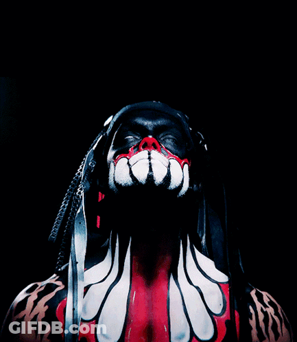 A Man With Dreadlocks And Red And White Paint On His Body GIF