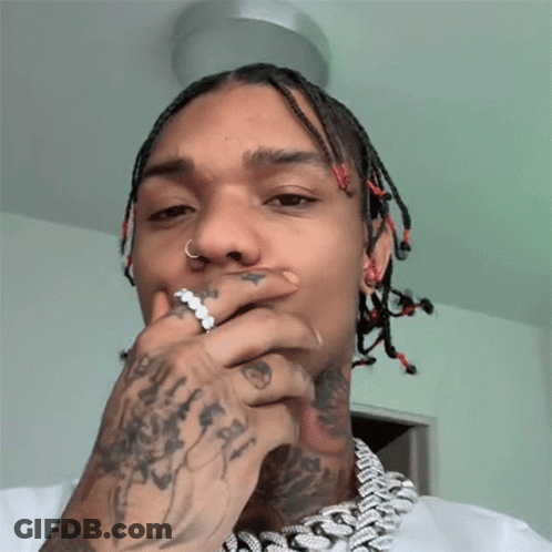 A Man With Dreadlocks Has A Ring In His Nose GIF