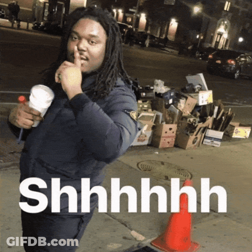A Man With Dreadlocks Holds His Finger To His Mouth And Says " Shhhh " GIF