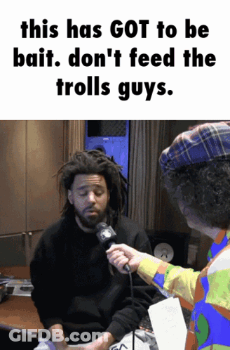 A Man With Dreadlocks Is Being Interviewed By A Man In A Clown Hat GIF
