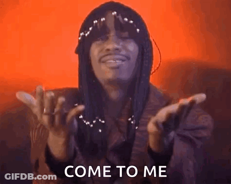 A Man With Dreadlocks Is Making A Come To Me Gesture With His Hands In The Air . GIF