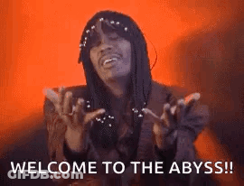 A Man With Dreadlocks Is Making A Funny Face And Saying Welcome To The Abyss . GIF