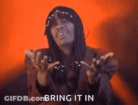 A Man With Dreadlocks Is Making A Funny Face With His Hands In The Air . GIF