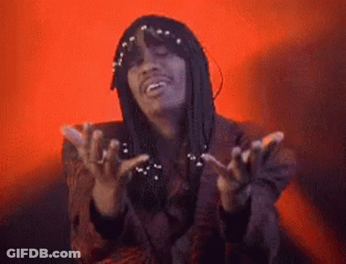 A Man With Dreadlocks Is Making A Funny Face With His Hands Outstretched . GIF