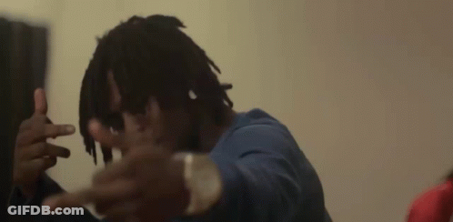 A Man With Dreadlocks Is Making A Peace Sign With His Hands GIF