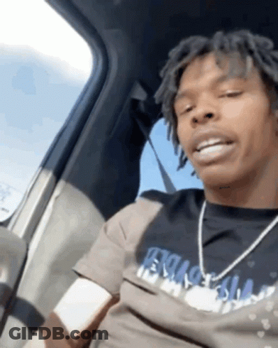 A Man With Dreadlocks Is Sitting In A Car Wearing A T-Shirt That Says ' Ecstasy ' GIF