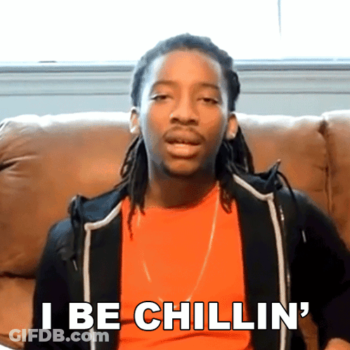 A Man With Dreadlocks Is Sitting On A Couch And Says " I Be Chillin ' " GIF