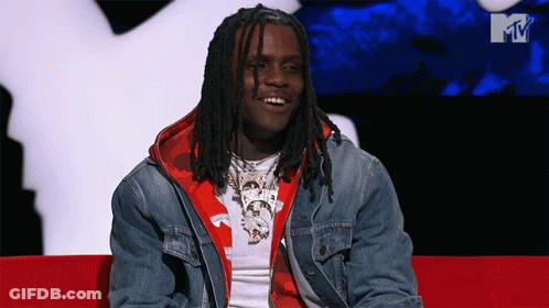 A Man With Dreadlocks Is Sitting On A Red Couch In Front Of An Mtv Logo GIF