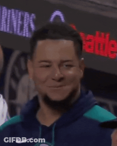 A Man With Dreadlocks Is Smiling And Wearing A Blue Sweatshirt GIF