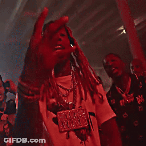 A Man With Dreadlocks Is Standing In A Dark Room . GIF