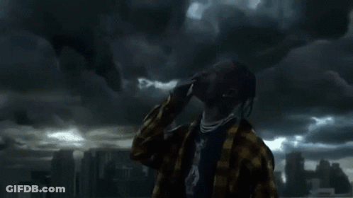 A Man With Dreadlocks Is Standing In Front Of A Cloudy Sky Looking Up . GIF