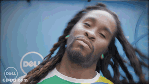 A Man With Dreadlocks Is Standing In Front Of A Dell Logo GIF
