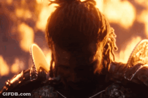 A Man With Dreadlocks Is Standing In Front Of A Flame GIF