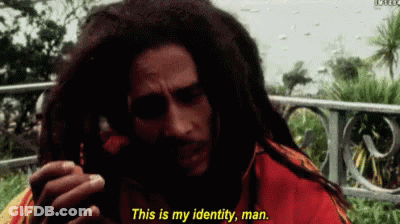 A Man With Dreadlocks Is Talking On A Cell Phone And Says " This Is My Identity Man " GIF