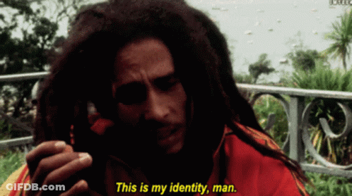 A Man With Dreadlocks Is Talking On A Cell Phone And Says This Is My Identity Man GIF
