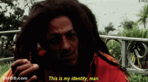A Man With Dreadlocks Is Talking On A Cell Phone And Says " This Is My Identity Man " GIF