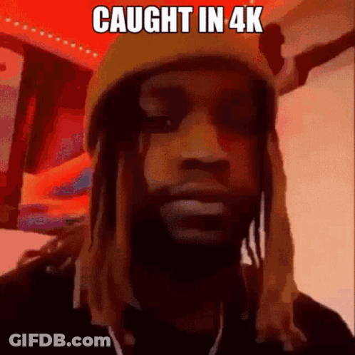 A Man With Dreadlocks Is Wearing A Beanie And Headphones . GIF