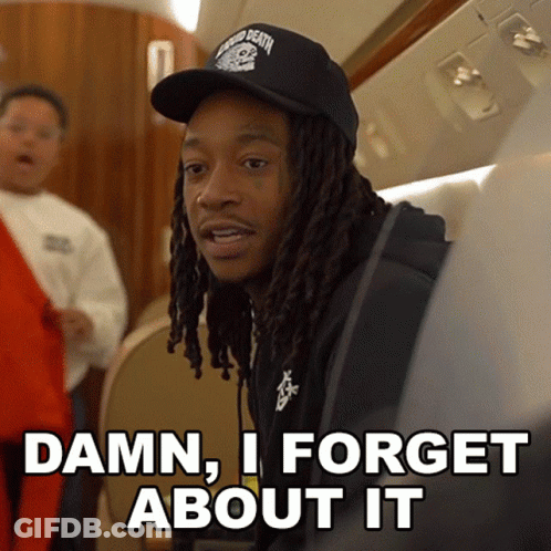 A Man With Dreadlocks Is Wearing A Black Hat And Says " Damn I Forget About It " GIF
