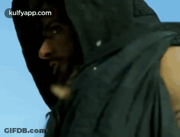 A Man With Dreadlocks Is Wearing A Black Jacket With A Hood GIF