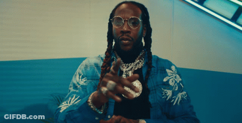 A Man With Dreadlocks Is Wearing A Blue Jacket GIF