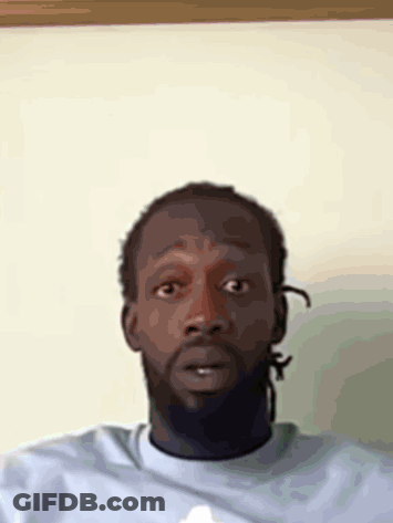 A Man With Dreadlocks Is Wearing A Blue Shirt GIF