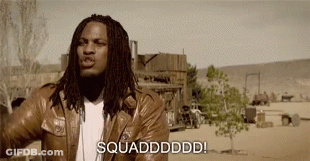 A Man With Dreadlocks Is Wearing A Brown Leather Jacket And Standing In The Desert . GIF