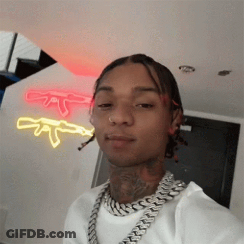 A Man With Dreadlocks Is Wearing A Chain Around His Neck And Taking A Selfie GIF