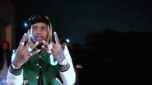 A Man With Dreadlocks Is Wearing A Green And White Jacket With The Letter C On It GIF