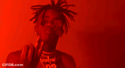 A Man With Dreadlocks Is Wearing A Necklace With The Number 99 GIF