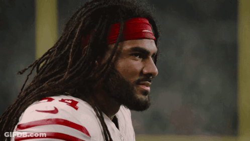 A Man With Dreadlocks Is Wearing A Nike Headband And A 49Ers Jersey GIF