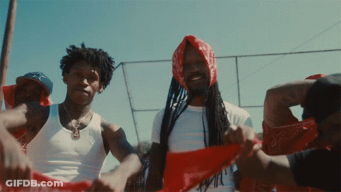 A Man With Dreadlocks Is Wearing A Red Bandana GIF