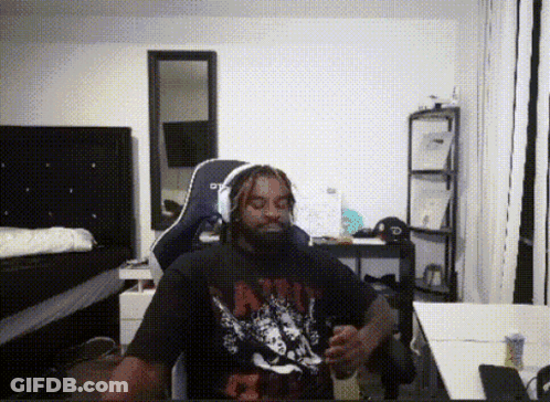 A Man With Dreadlocks Is Wearing A Shirt That Says ' Nirvana ' GIF