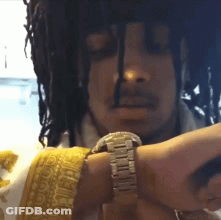 A Man With Dreadlocks Is Wearing A Watch On His Wrist GIF