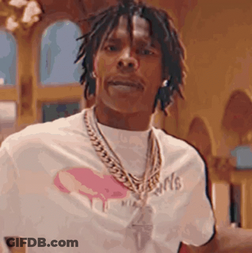 A Man With Dreadlocks Is Wearing A White Shirt And A Gold Chain . GIF