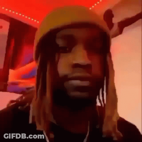 A Man With Dreadlocks Is Wearing A Yellow Hat And Earphones . GIF